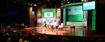 Panelists on a stage at Planet Forward.